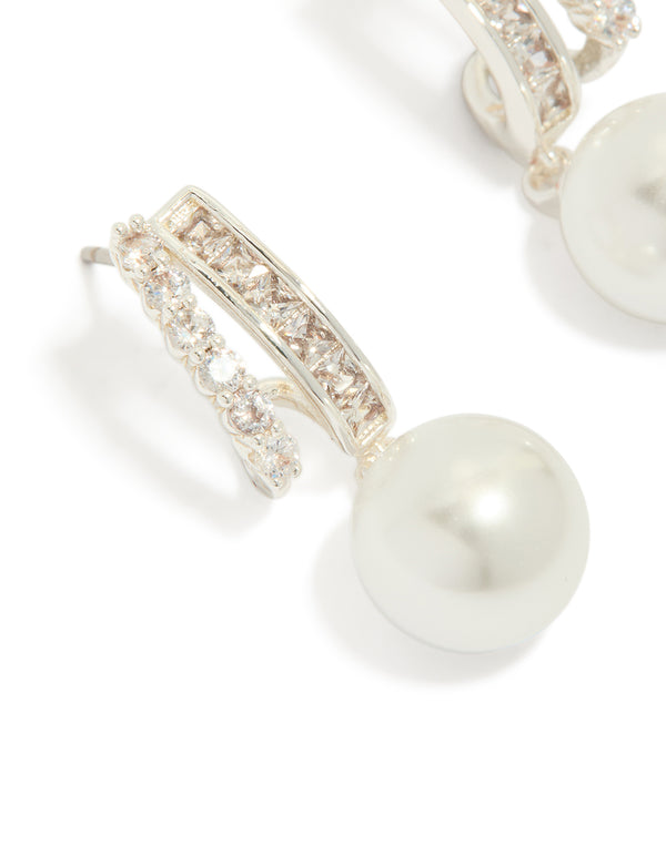 Featuring silver plated cubic zirconia illusion pearl drop earrings with hoop closure close up view