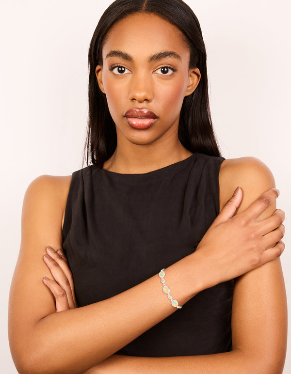 Crafted from silver plated blue cubic zirconia large bezel trio toggle bracelet with statement design on model view