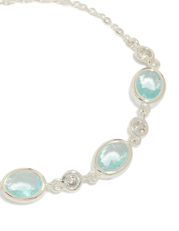 Presenting a silver plated blue cubic zirconia large bezel trio toggle bracelet with statement design close up view