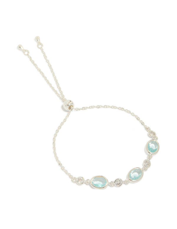 Showcasing a silver plated blue cubic zirconia large bezel trio toggle bracelet with statement design front view