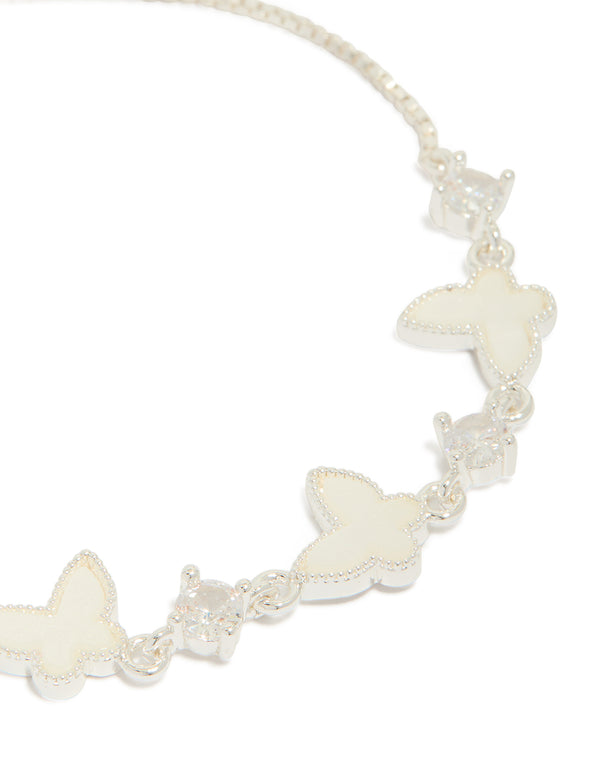 Crafted in silver plated finish, this toggle bracelet features smooth butterfly charms and cubic zirconia inlay close up view