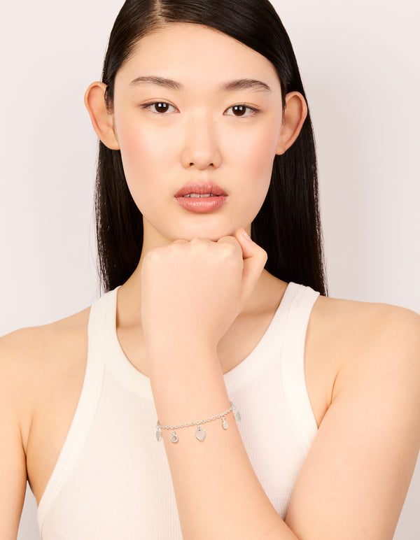 Beautifully designed is this silver plated cubic zirconia heart charms toggle bracelet on model view