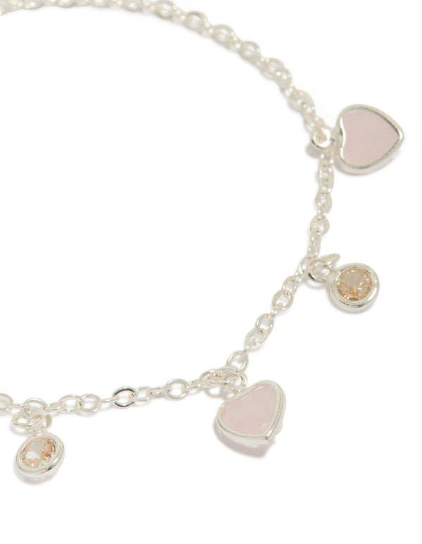 Showcasing silver plated cubic zirconia heart charms toggle bracelet close up view