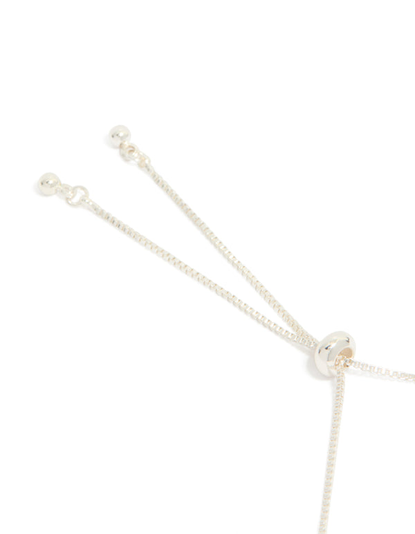 Highlighting the silver plated moon and heart charm toggle bangle with celestial features closure detail view