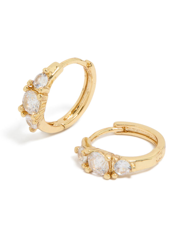 Discover these gold plated mixed sized cubic zirconia mini huggie earrings featuring huggie closure front view