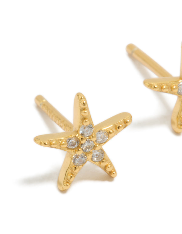 Featuring gold plated sterling silver cubic zirconia starfish earrings with ocean motifs in clear close up view