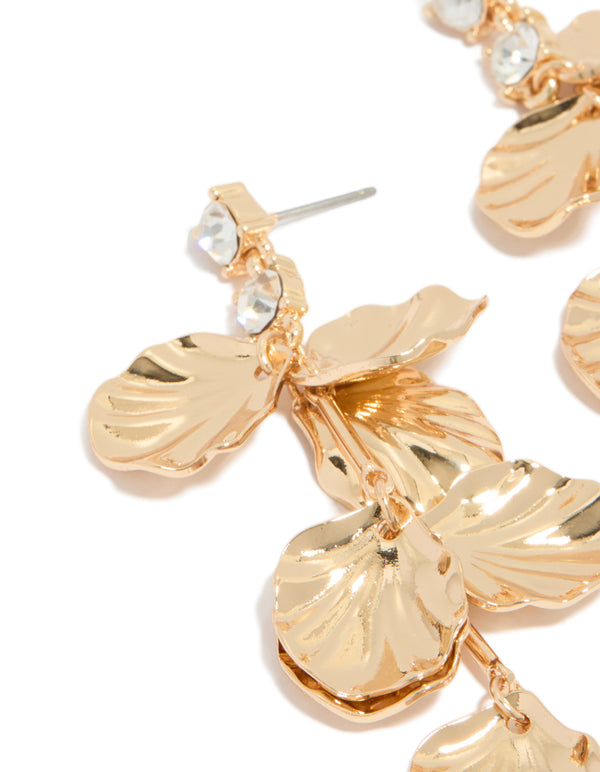 Featuring gold diamante and molten textured petal drop earrings with floral design in statement style close up view