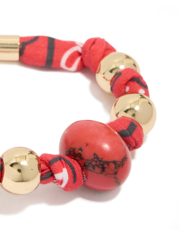 Crafted with beads accents in gold and red, this wrapped bracelet with stones close up view
