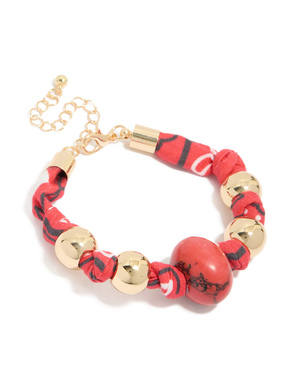 Featuring gold and red bead accents, this wrapped bracelet with stones front view