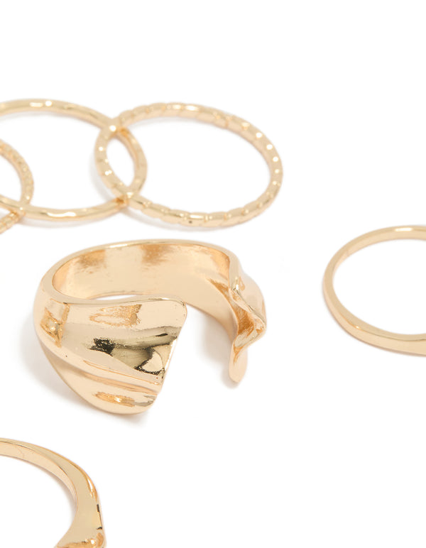 Featuring gold dainty organic rings in a 7-pack close up view