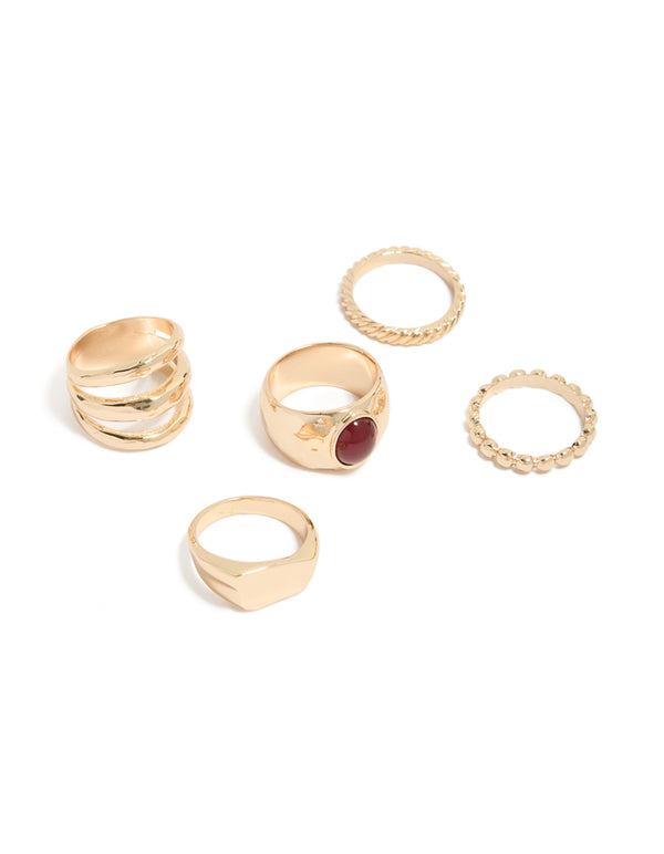 Showcasing a gold chunky ring 5-pack with maroon stone accents, and statement style front view