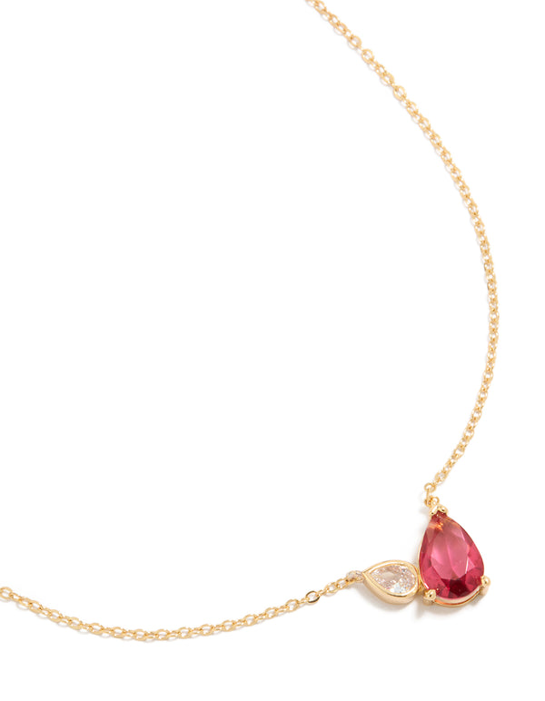 Featuring a gold plated pendant necklace with red cubic zirconia crystal close up view