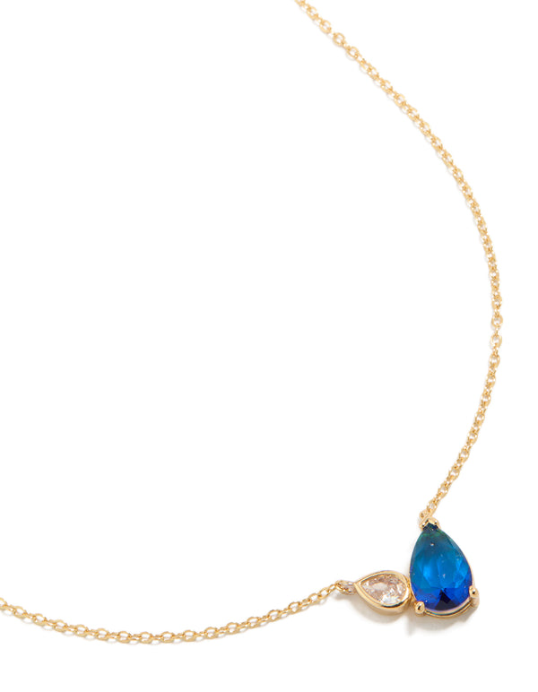 Showcasing a gold plated September blue cubic zirconia pendant necklace featuring crystal and dainty design close up view