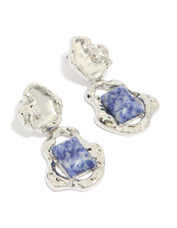Showcasing silver molten semi precious stone drop earrings featuring blue gemstones in an organic textured setting front view
