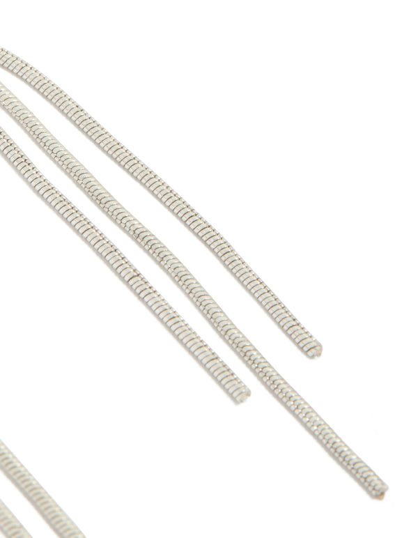 Detailed view of dainty silver drop earrings featuring celestial moon with black gemstone accents and tassel chain detailing post detail view