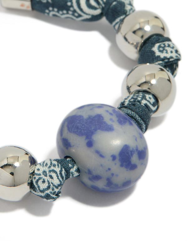 Crafted with beaded bracelet in teal and lightskyblue showcases intricate paisley details close up view