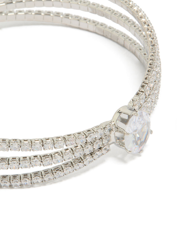 Highlighting a statement wrist cuff featuring cubic zirconia with oval stone cut in silver close up view