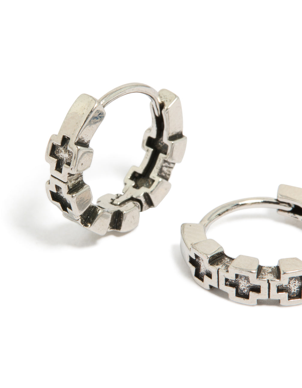 Crafted from waterproof brushed stainless steel with multiple cross details, these mens huggie hoop earrings in silver and black close up view