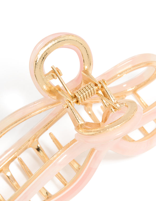 Designed with a bow claw clip in solid pink and gold detail view