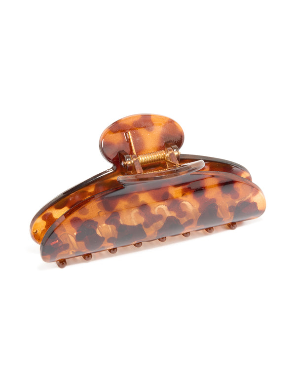 Crafted with a tortoiseshell pattern this arched claw clip in chocolate sienna and peru hues side view