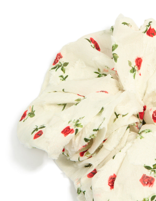 Designed with floral printed roses and leaf pattern, this statement scrunchie in ivory, red and olive shades detail view