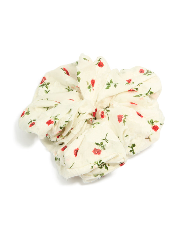Discover this statement scrunchie featuring floral printed roses with leaf accents in ivory, red and olive tones front view