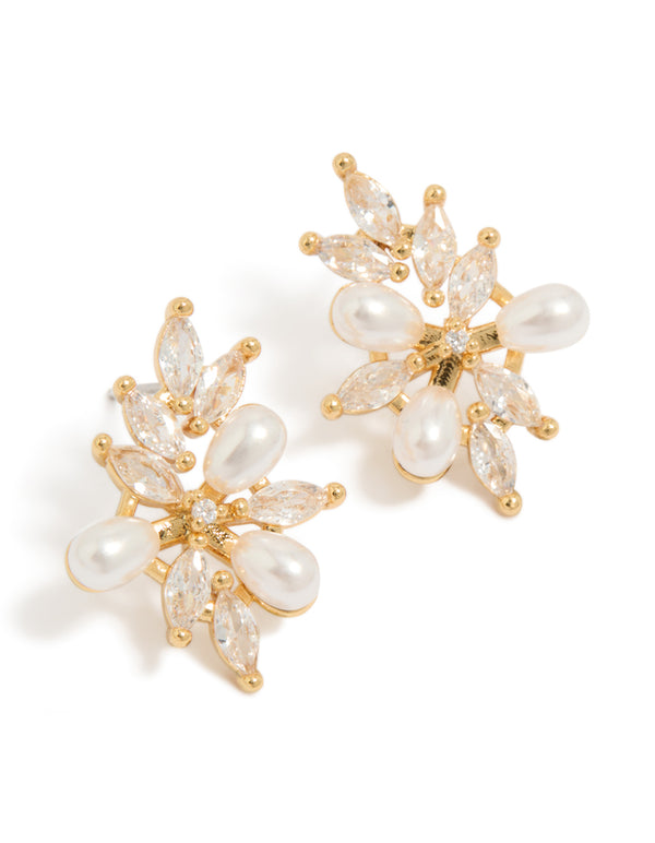Crafted from gold plated metal, these statement organic flower earrings with pearls and cubic zirconia in ivory tones front view