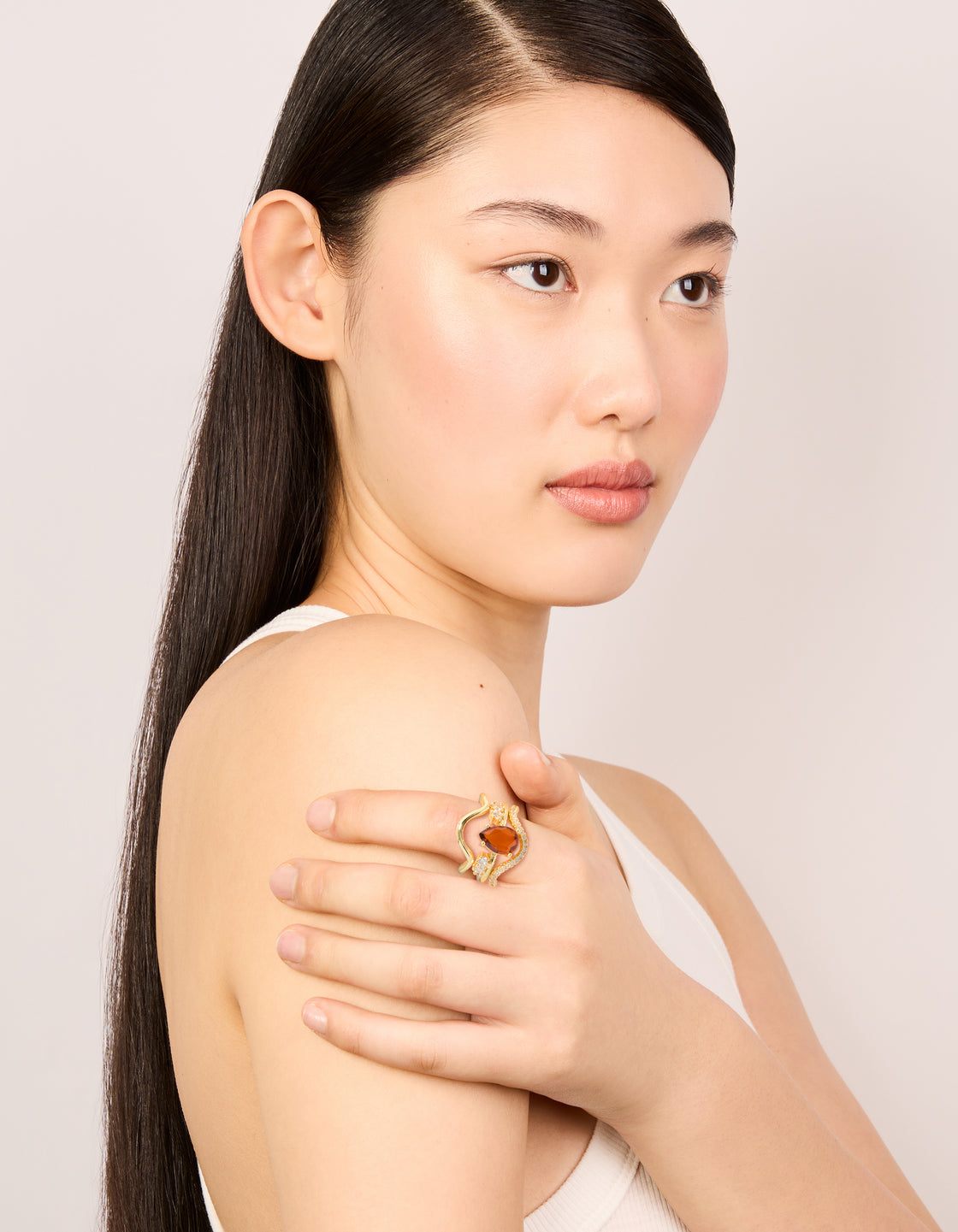 Featuring gold plated red cubic zirconia teardrop and wavy rings in a statement 3-pack with crystal accents on finger view