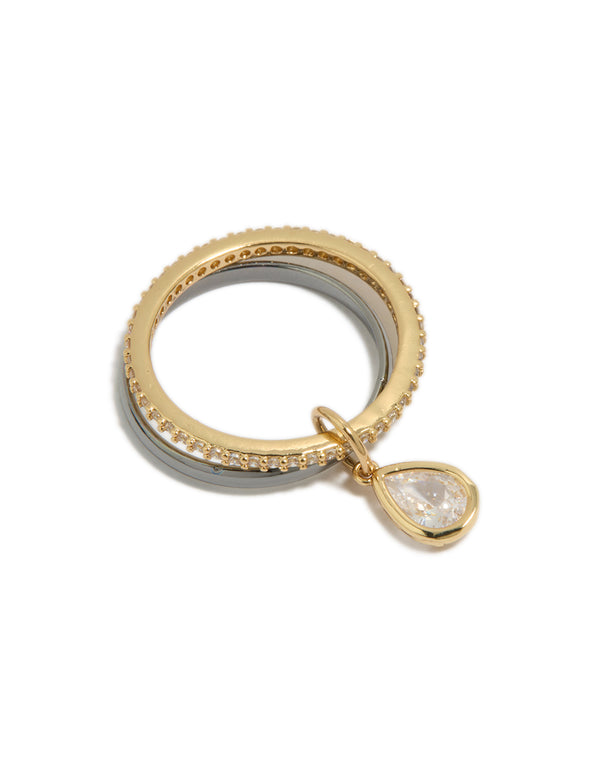 Showcasing a mixed metal plated cubic zirconia band and stacked ring with charm featuring gold and silver tones close up view