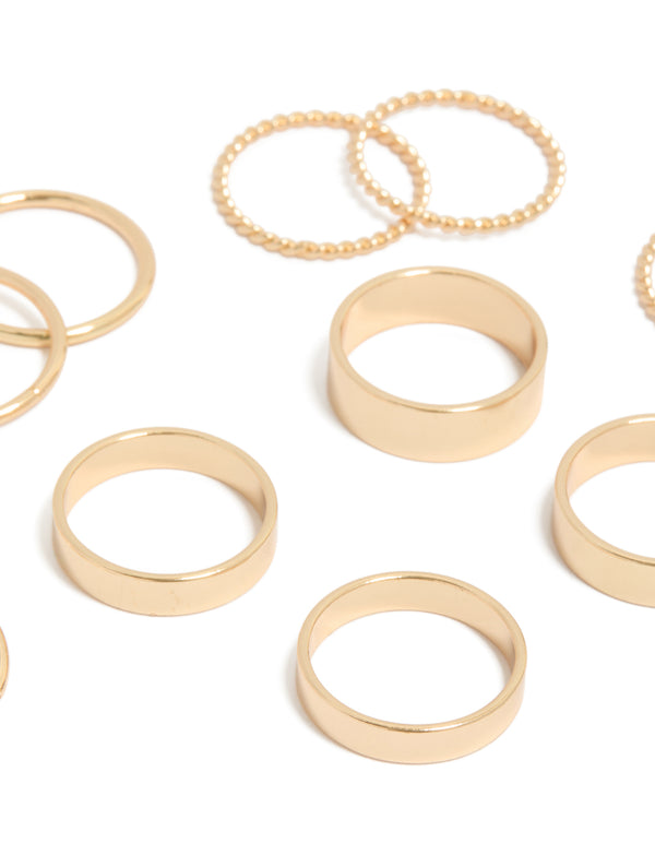 Showcasing gold thick and simple rings in an 8-pack with beaded textures close up view