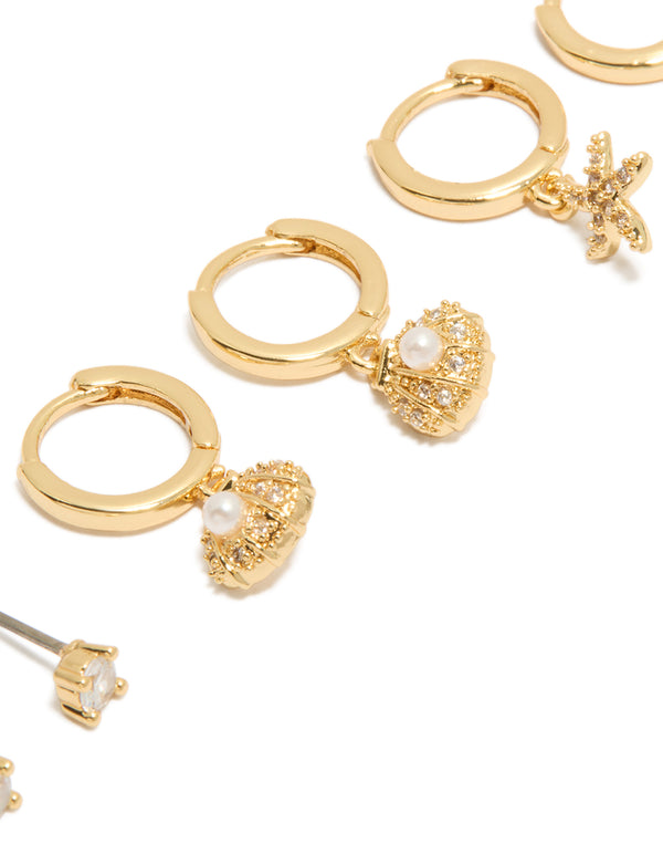 Designed with gold plated cubic zirconia studs and mini starfish huggie earrings 3-pack featuring ocean crystal shell and pearl close up view