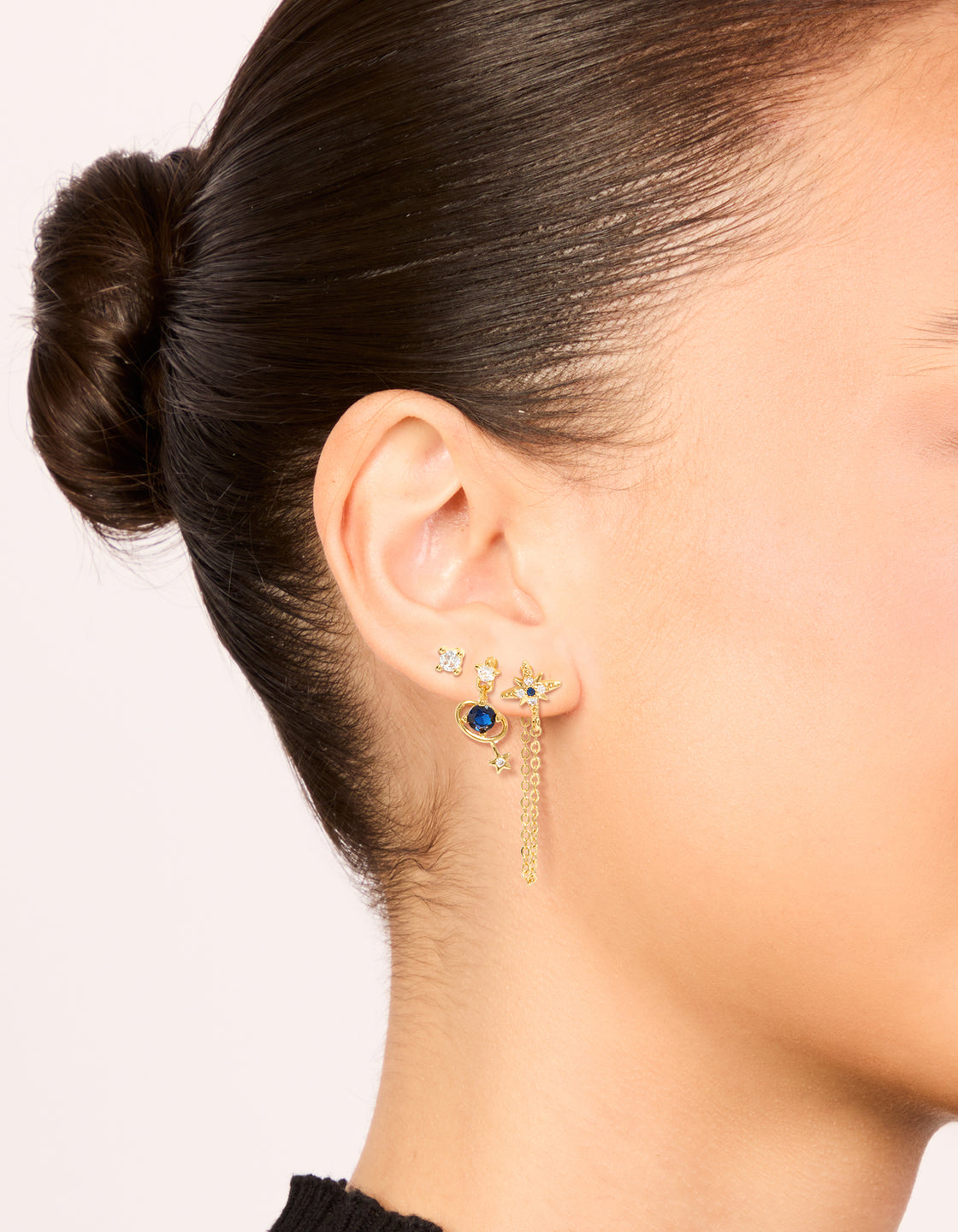 Featuring gold plated cubic zirconia celestial chain and mini stud earrings 3-pack with charm and star features on ear view