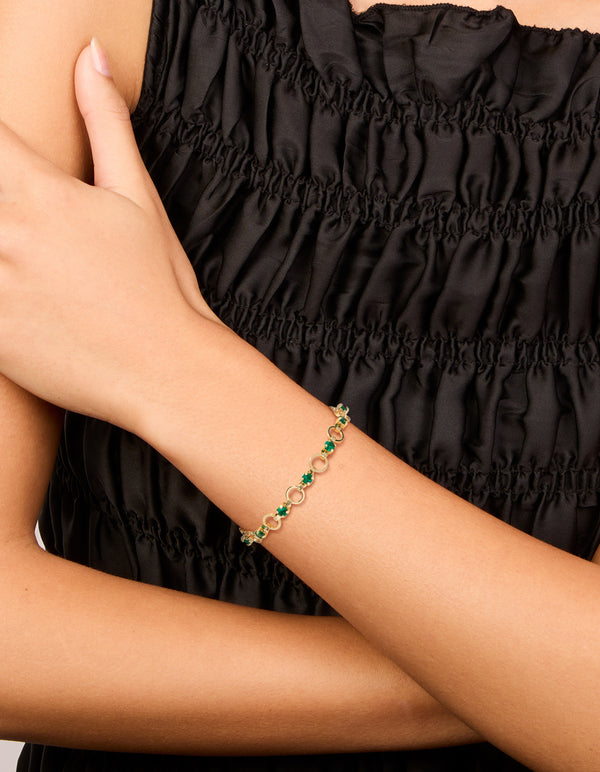 Elegant gold plated alternating round green cubic zirconia link bracelet on wrist view