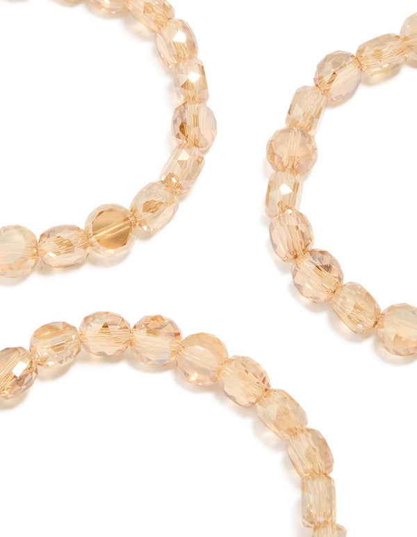 Highlighting amber beaded stretch bracelets in a 3-pack with wheat and burlywood tones close up view