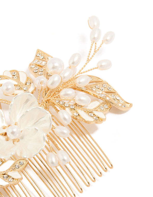 Elegantly designed floral hair comb with leaf accents, pearl embellishments, and ivory petals in gold detail view