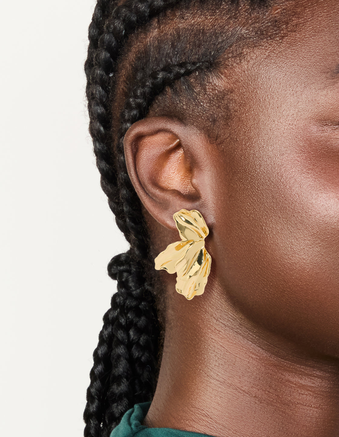 Crafted from gold plated organic half flower statement earrings with floral and leaf details on ear view