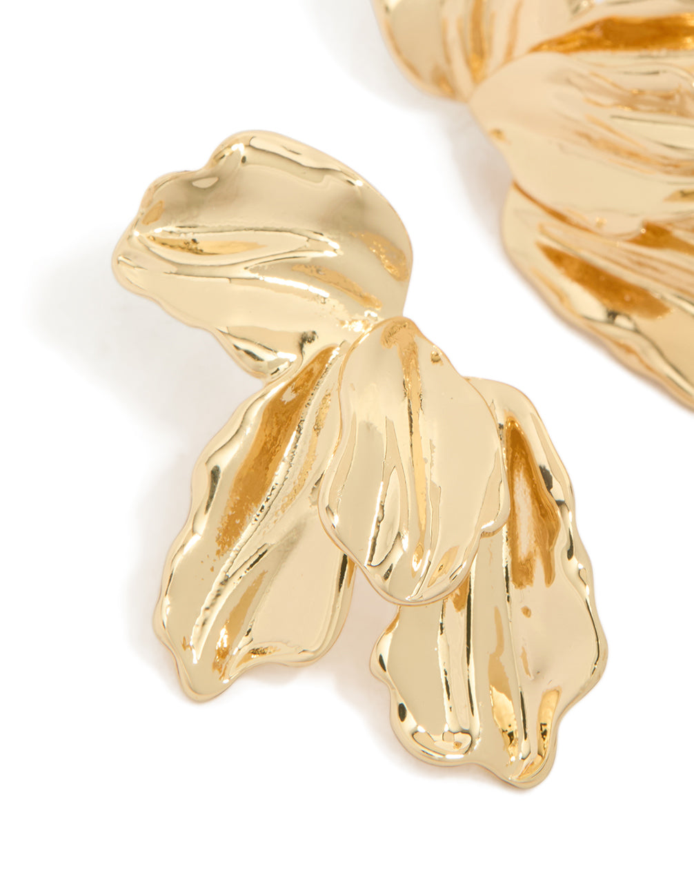 Highlighting the organic half flower statement earrings in gold plated material with floral and leaf features close up view