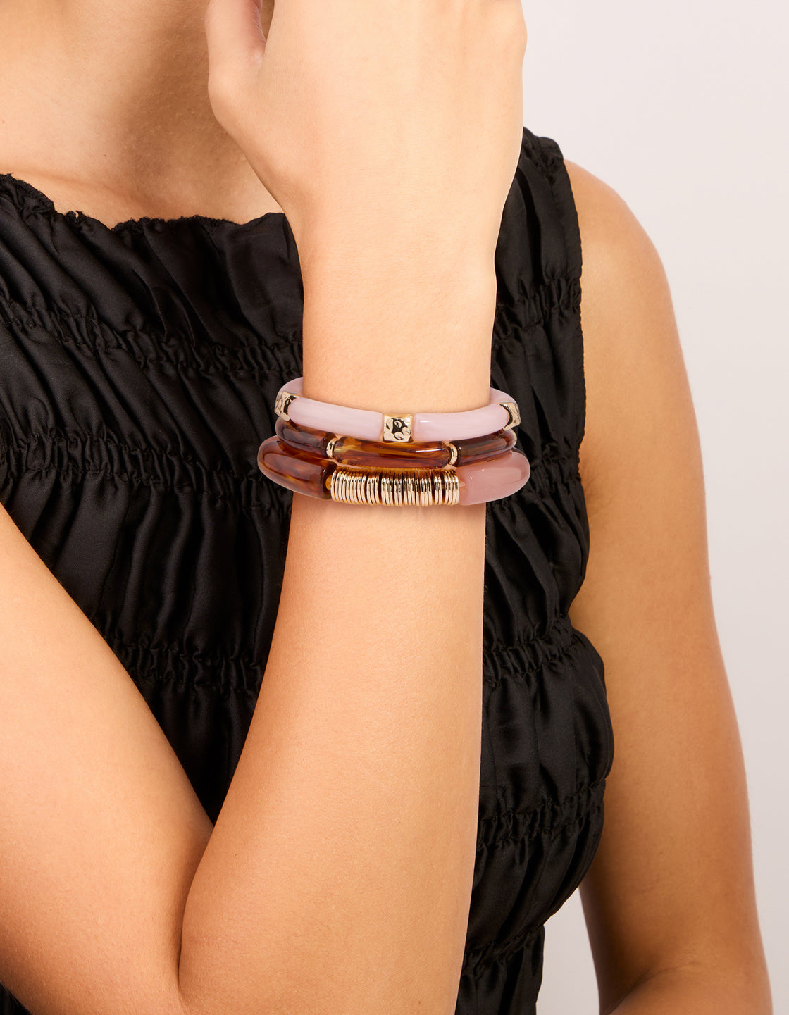 Featuring mixed pink resin and gold stretch bracelets with beaded accents in a 3-pack on wrist view