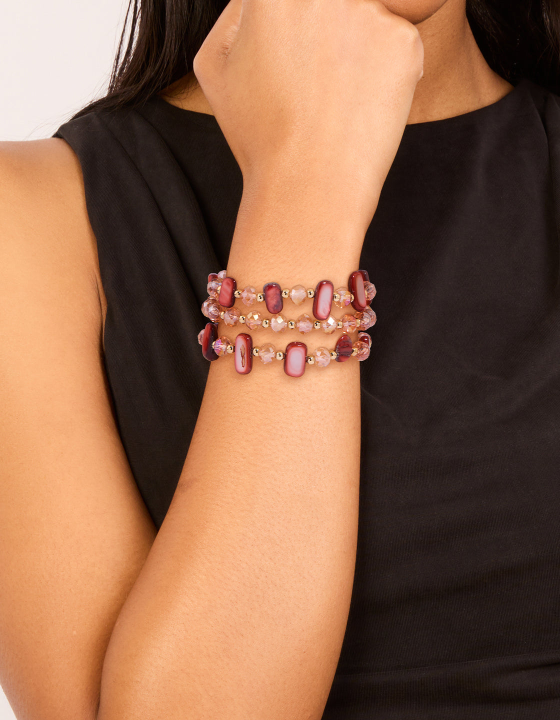 Crafted from beaded stretch material in pink, light coral, gold, and indian red, 3-pack on wrist view