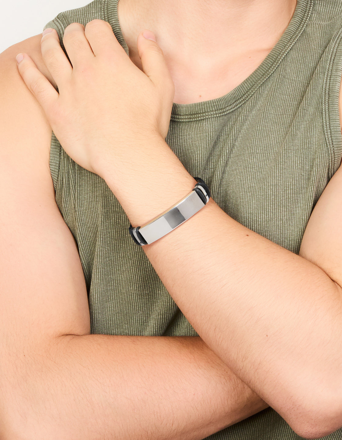 Featuring a mens waterproof bar bracelet with stainless steel and braided black PU leather band on wrist view