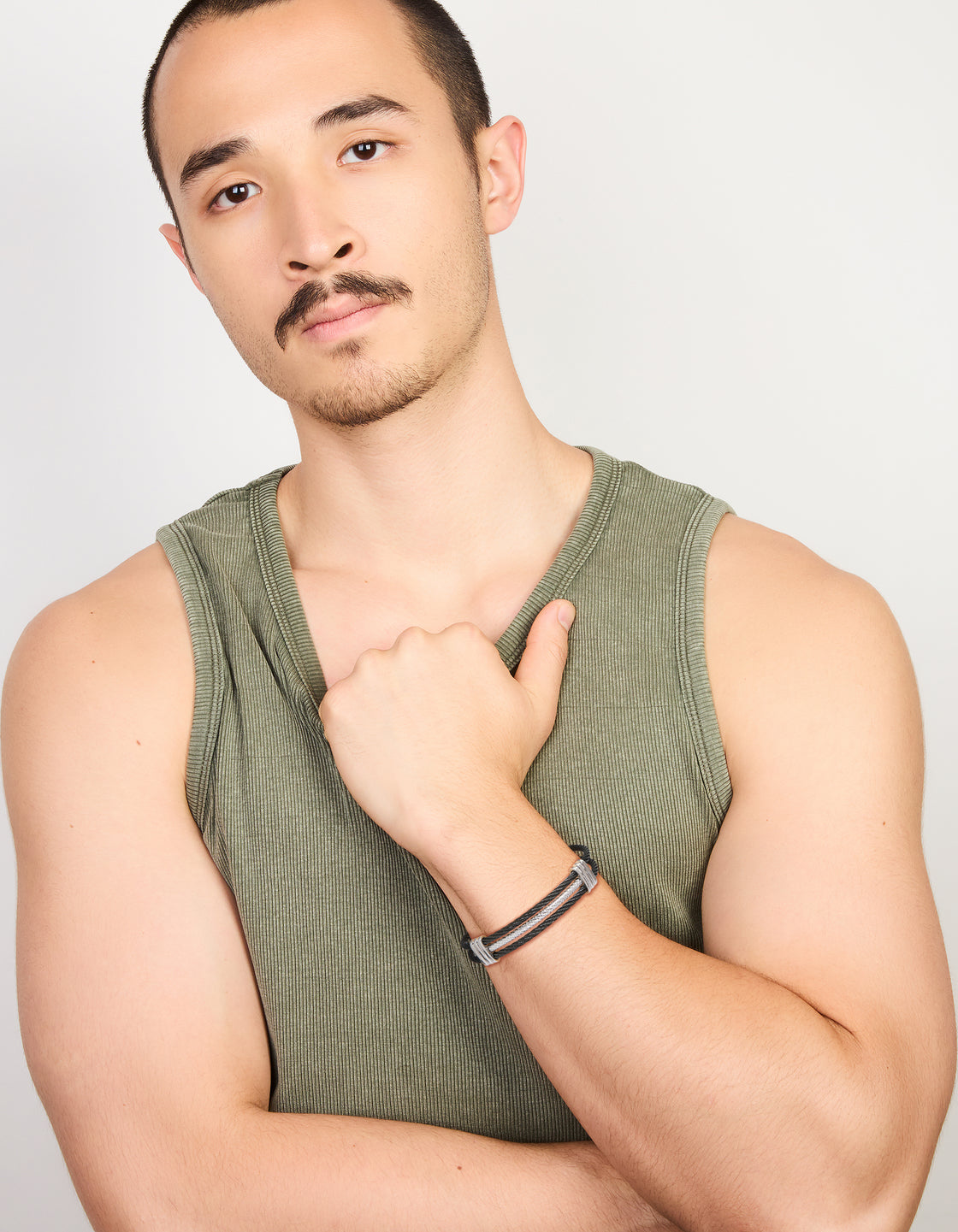 Displaying a mens waterproof stainless steel black and silver wire twisted wrist cuff bracelet on model view