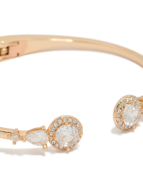 Displaying a gold cubic zirconia hinged circle open front wrist cuff bracelet close up view