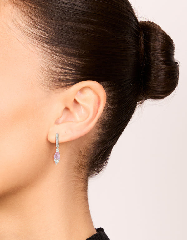 Discover statement huggie drop earrings crafted from silver plated metal with pink cubic zirconia on ear view