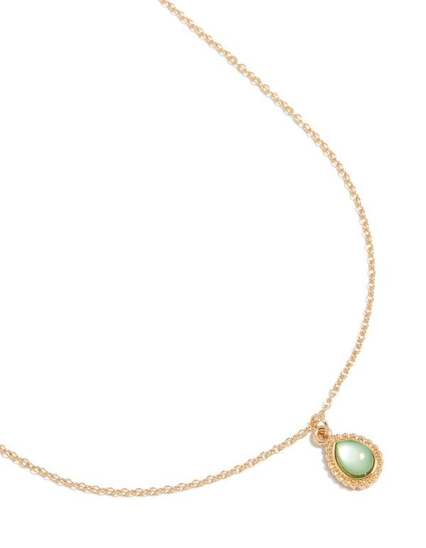 Presenting a simple teardrop pendant necklace featuring gold and pale green tones front view
