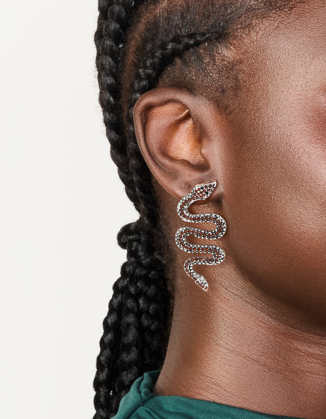 Featuring silver orange diamante snake statement earrings on ear view
