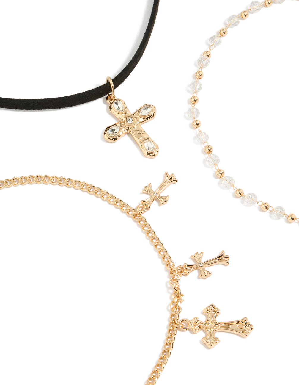 Highlighting gold textured cross and plain black choker necklaces set with beaded pearl charm details close up view