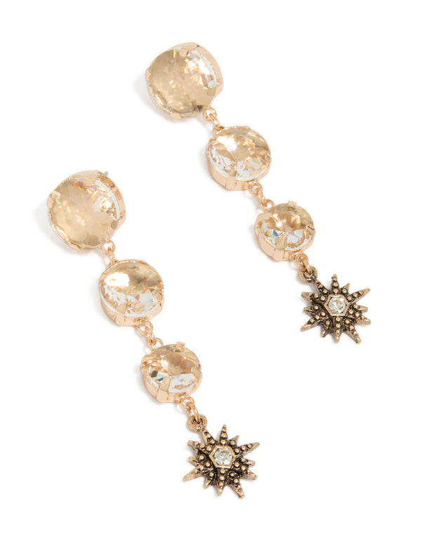 Showcasing gold triple jewel drop earrings featuring celestial star charms front view