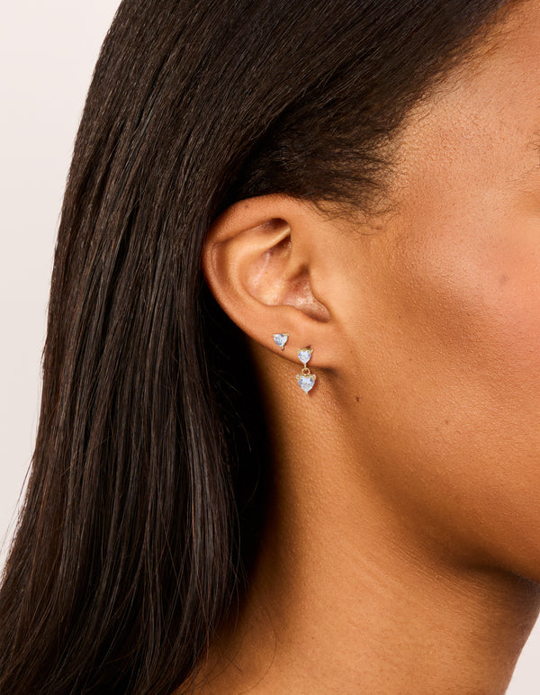 Beautifully crafted waterproof heart-shaped stud and drop earrings featuring gold plated stainless steel with cubic zirconia stones in a statement 2-pack on ear view