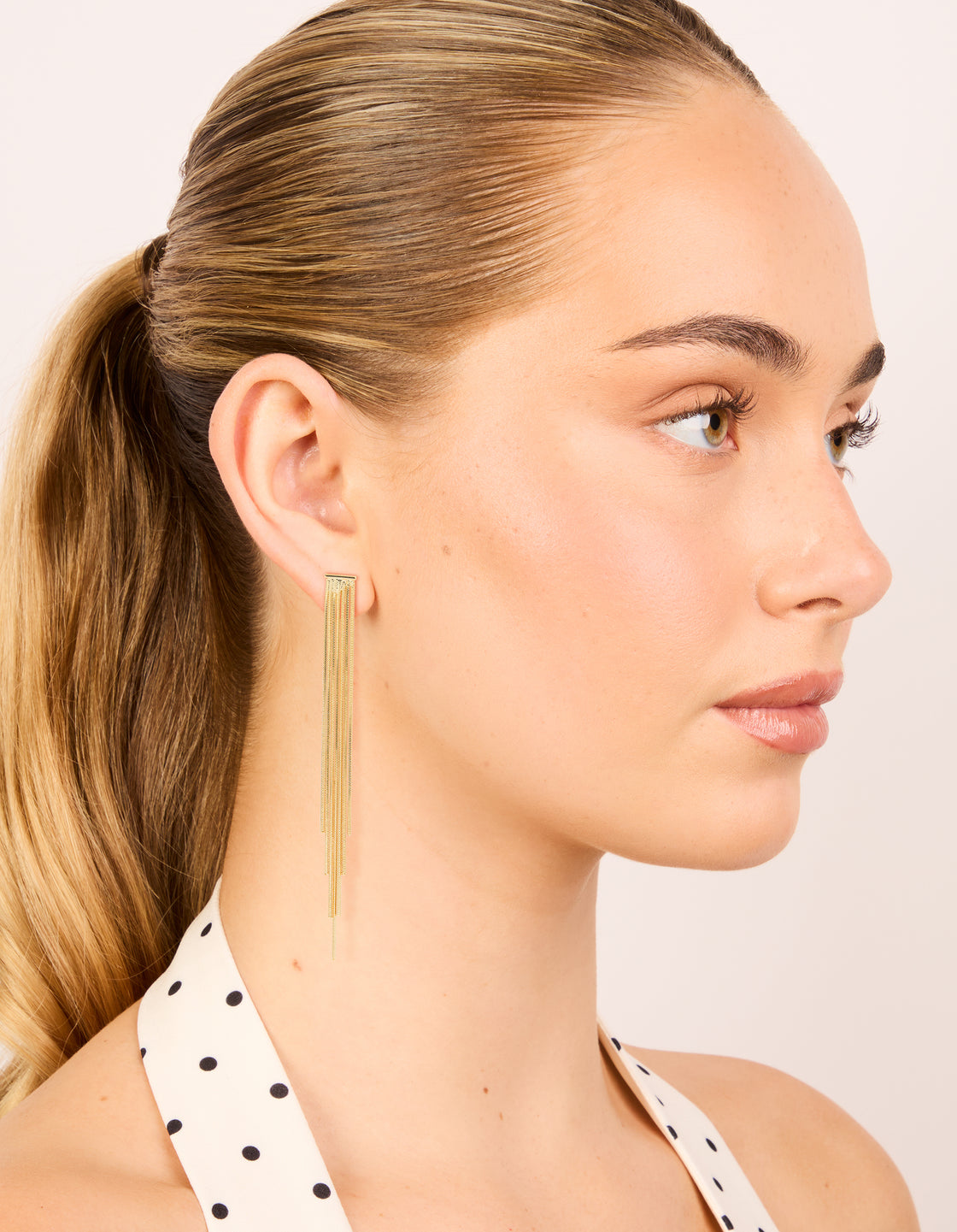 Elegant statement tassel gold plated waterfall chain drop earrings on model view