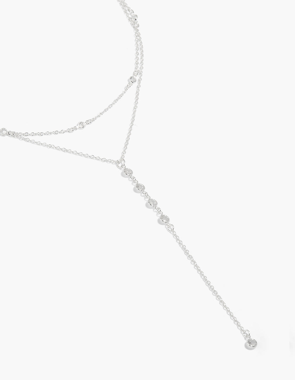 Showcasing a cubic zirconia layered Y-necklace crafted from plated material in silver close up view
